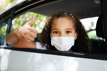 Image showing Covid, thumbs up and portrait of a girl in a car for travel, road trip safety and compliance. Free, satisfaction and a little child showing a hand gesture with a face mask for protection in transport