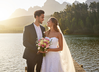 Image showing Wedding, couple and lake with a bride feeling love, care and support from marriage together. Nature, happiness and relationship bond of young people with a happy smile from trust and commitment event