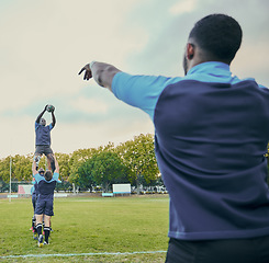 Image showing Sports, rugby and team outdoor, men playing game with energy and fitness, huddle and action on field. Jump, catch and ball with exercise and professional match, sport club with male group and active