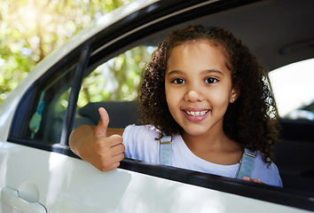 Image showing Portrait, road trip and girl with a thumbs up in a car for travel, content with transportation and ride. Happy, review and a child with a hand gesture for transport satisfaction, approval and like