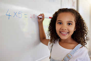 Image showing Whiteboard, math and portrait of girl learning, studying and education in classroom. Development, mathematics and face of happy kid or student with equations, numbers and multiplication in school.