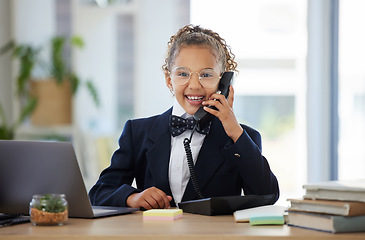 Image showing Portrait, children and telephone with a business girl playing in an office as a fantasy employee at work on a laptop. Kids, phone call and a child working at a desk while using imagination to pretend