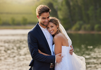 Image showing Happy wedding couple, hug and smile by water lake for romantic honeymoon getaway in nature. Man and woman hugging in happiness for marriage relationship or embracing loving commitment in the outdoors