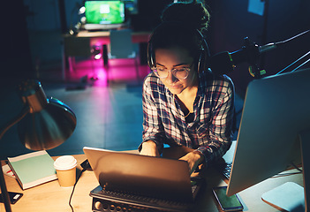 Image showing Live streaming, computer and podcast woman typing news article, broadcast report or planning platform strategy at night. Journalist or person on laptop and microphone for student politics or radio