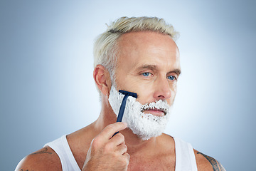 Image showing Senior man, razor and shaving cream for beard grooming, skincare or hair removal against a studio background. Mature male face with shaver, creme or foam product for clean hygiene or facial treatment