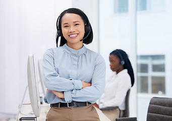 Image showing Asian woman, call center and arms crossed in portrait, communication and CRM, headset with mic in office. Contact us, customer service or telemarketing, female consultant with smile and help desk