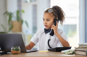 Image showing Children, telephone and a girl having fun in an office as a fantasy businesswoman at work on a laptop. Kids, phone call and a female child working at a desk while using her imagination to pretend