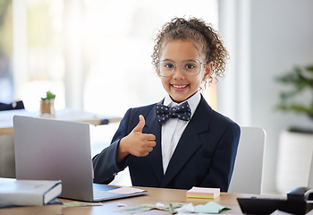 Image showing Girl child, playing business and thumbs up with laptop for success, happiness and career games. Kid, happy smile and hand sign for deal, agreement and future by computer at desk in modern office