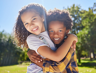 Image showing Portrait, kids and friends hugging in a park together for fun, bonding or playing in summer. Hug, children or diversity with girl and boy best friends embracing in a garden during the day