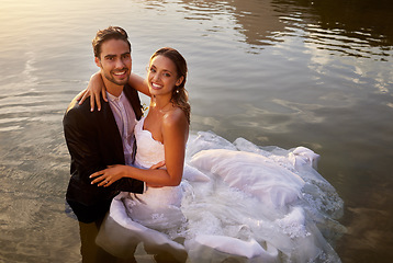 Image showing Wedding, love and portrait of couple in the lake to celebrate their marriage in nature. Happy, smile and young wet bride and groom swimming in the pond water for romantic playful outdoor celebration.