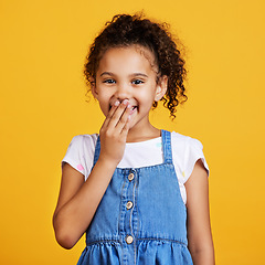 Image showing Laughing, happy and portrait of a child in a studio with a comic funny joke and positive mindset. Happiness, smile and face of a girl kid model giggling for comedy while isolated by yellow background