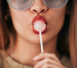 Image showing Lollipop, woman and lips with lipstick, cosmetics and gen z style eating a sweet candy. Mouth, young person and food with makeup aesthetic and a hungry female model with sweets, dessert and product