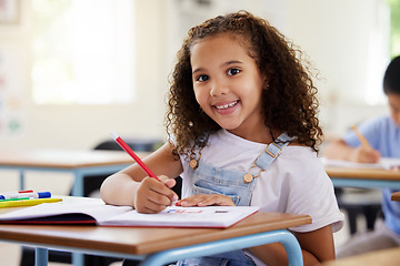 Image showing Learning, drawing and portrait of girl in classroom exam, education or studying with book. Preschool smile, development and happy kid or student coloring for creative art in notebook in kindergarten.