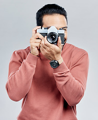 Image showing Man with camera, photography and artist, taking picture with art isolated on white background. Photographer, focus with lens and creativity with vintage technology and creative male in studio