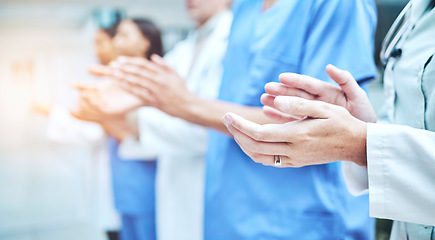 Image showing Clapping hands, celebration and team of doctors in the hospital with success in teamwork or collaboration. Solidarity, professional and group of healthcare workers with applause in a medical clinic.