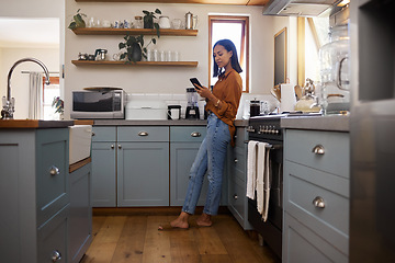 Image showing Coffee break, phone and woman standing in kitchen while browsing internet, checking social media or reading email. Chat, connect and relax, work from home lifestyle and latino freelancer in apartment