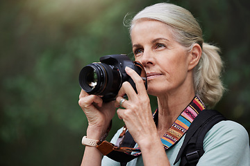 Image showing Nature, hiking and mature woman taking pictures, fitness and memories with wellness, healthy lifestyle and wireless device. Senior female tourist, lady and photographer with camera, hike and walking