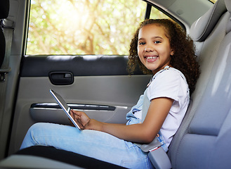 Image showing Car ride, child portrait and tablet with a happy kid in a backseat with transportation travel. Video streaming, smile and happiness of a girl on road trip and adventure for holiday riding in vehicle