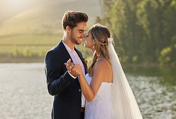 Image showing Wedding, dance and couple love by lake with care and support from marriage together by water. Nature, happiness and holding hands of young people with a happy smile from trust and commitment event