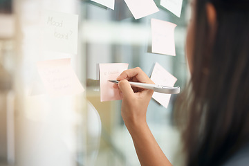 Image showing Hands, brainstorming and woman writing notes for office schedule, agenda and mindmap goals at window. Closeup female employee planning ideas at glass for solution, information and strategy objectives