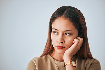 Image showing Serious woman, thinking and space for idea in studio with advertising or product placement. Face of female on white background with doubt, planning or contemplating problem, plan or decision