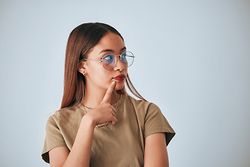 Image showing Woman, thinking and space for idea with glasses in studio for advertising or product placement mockup. Female with hand on chin for doubt or planning logo or branding decision on a white background
