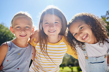 Image showing Happy, friendship and portrait of children in a park playing together outdoor in nature. Happiness, diversity and girl kid friends with smile standing, embracing and bonding in a outside green garden