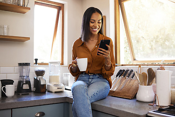 Image showing Smile, kitchen and woman with phone on coffee break while browsing internet, checking social media meme or reading email. Chat, connect and work from home lifestyle, latino freelance in apartment.