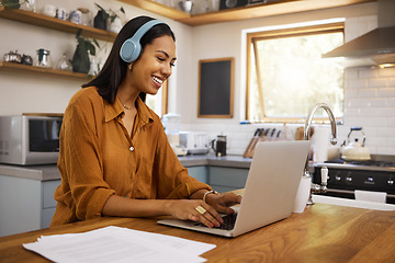 Image showing Home, remote work and business woman on laptop for research project, strategy and planning in kitchen. Freelancer, smile and girl with headphones for music with documents, computer and working online