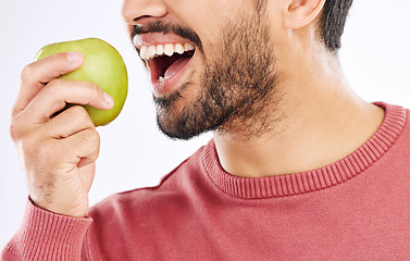 Image showing Hand, apple and man in studio for diet, nutrition and weight loss with healthy breakfast on white background. Fruit, snack and male nutritionist eating organic, clean and fiber detox routine isolated