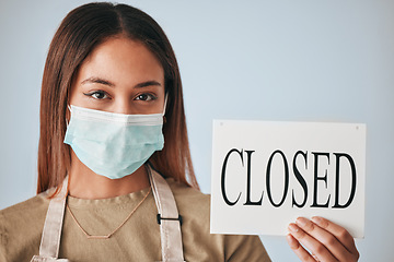 Image showing Woman, closed sign and mask for covid in studio portrait for safety, wellness or board by background. Entrepreneurship, small business owner and paper poster for warning in management job by backdrop