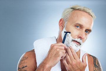 Image showing Senior man, razor and shaving beard with cream for skincare grooming or hair removal against studio background. Portrait of mature male with shaver, creme or foam for clean facial treatment on mockup