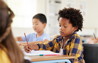 Image showing .Education, writing and black boy in classroom learning, exam or studying with book. Preschool, development and serious kid and student write notes in notebook, reading and knowledge in kindergarten.