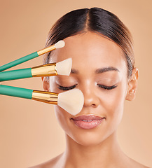 Image showing Makeup brushes, eyes closed or girl with facial self care or beauty cosmetics on studio background. Face model, smile or beautiful woman marketing luxury female products or natural glowing skincare