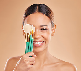 Image showing Makeup brushes, portrait or happy woman with eyeshadow, facial products or self care on studio background. Face model, smile or young girl smiling with beauty cosmetics or natural glowing skincare