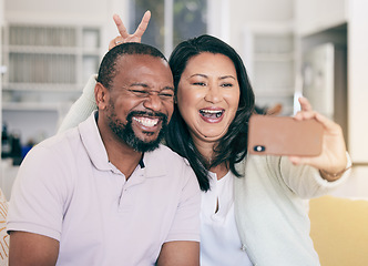 Image showing Senior black couple, selfie or happy in home together for silly, social media or relax with peace sign hand. Mature man, woman and digital photography app in house for embrace, bonding and bunny ears