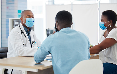 Image showing Covid, healthcare and doctor consulting a black couple in a hospital for wellness, insurance or treatment. Medical, health or trust with a medicine professional talking to a man and woman in a clinic