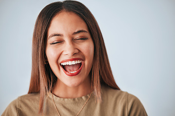 Image showing Woman is laughing, happiness and face with freedom isolated on studio background, comedy and care free. Headshot, young female and joy with laughter, funny and mockup with humor and positive energy
