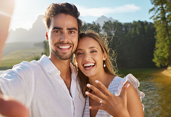 Image showing Couple, portrait selfie and engagement by lake for celebration, happiness and excited for future. Man, woman and photography for social media, profile picture and romance for love, proposal and goals