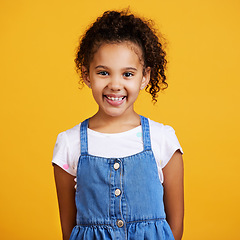 Image showing Studio, portrait and happy child with a smile on face isolated on a yellow background. Cute hispanic young girl kid model with happiness, carefree and positive attitude in casual clothes for fashion