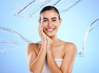 Image showing Happy woman, water splash and portrait smile for skincare moisturizer, product or cream against a blue studio background. Calm female face in natural beauty cosmetics, hygiene or facial treatment