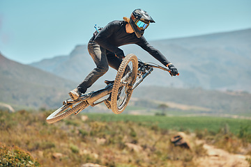 Image showing Fitness, extreme sports and mountain bike with man in nature for cycling, jump and adventure. Adrenaline junkie, performance and stunt with athlete riding in outdoors for action, risk and training