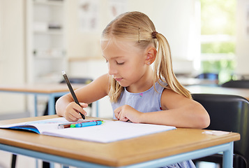 Image showing Education, drawing and girl in classroom learning, exam or studying with book. Preschool, development and serious kid and student with creative art in notebook, writing and knowledge in kindergarten.