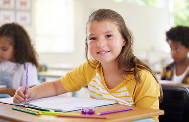 Image showing Education, writing and portrait of girl in classroom learning, exam or studying with book. Preschool smile, development and happy kid or student write notes for knowledge in notebook in kindergarten.