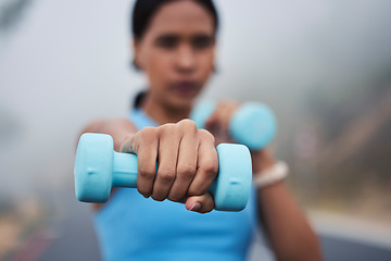 Image showing Woman, hand with weightlifting and fitness, dumbbell and closeup with muscle training outdoor in street. Exercise, strong female and fist, healthy and active lifestyle with weights and wellness