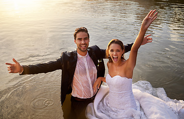 Image showing Lake, portrait of wet bride and groom standing in water together with excited smile and playful romance. Love, marriage and happy couple celebrate romantic, loving relationship and wedding in nature.