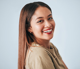 Image showing Woman, smile portrait and happiness of a gen z female in a studio with gray background. Isolated, happy and freedom from a person feeling carefree, youth and confidence with laughter from motivation