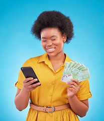 Image showing Black woman, phone and money fan with smile, winning and finance goal in studio by blue background. Girl, smartphone and cash in hand from online casino, gambling or esports app on social media chat