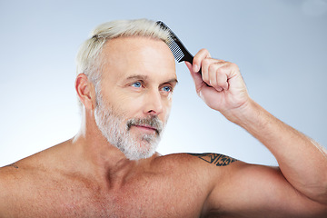 Image showing Old man, comb hair and grooming, beauty and haircare with hygiene and skin isolated on studio background. Senior male, cosmetics and brushing with cosmetology, routine and hairstyle with self care