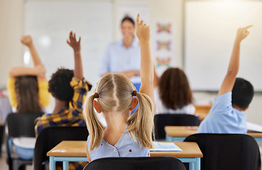 Image showing Answering, back and children raising hand in class for a question, answer or vote at school. Teaching, academic and a student asking a teacher questions while learning, volunteering or voting